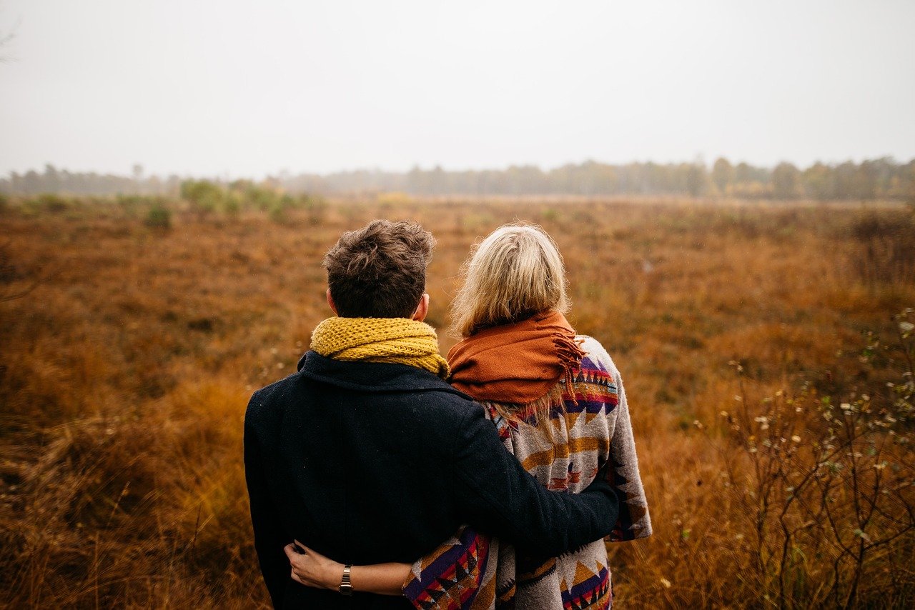 couple, hug, together, winter clothes, winter clothing, warm clothes, pair, lovers, grass, outdoor, field, people, nature, man, woman, dating